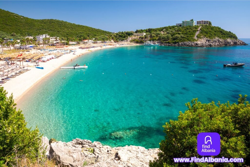 Sunset over Jale Beach Albania with turquoise waters and boats